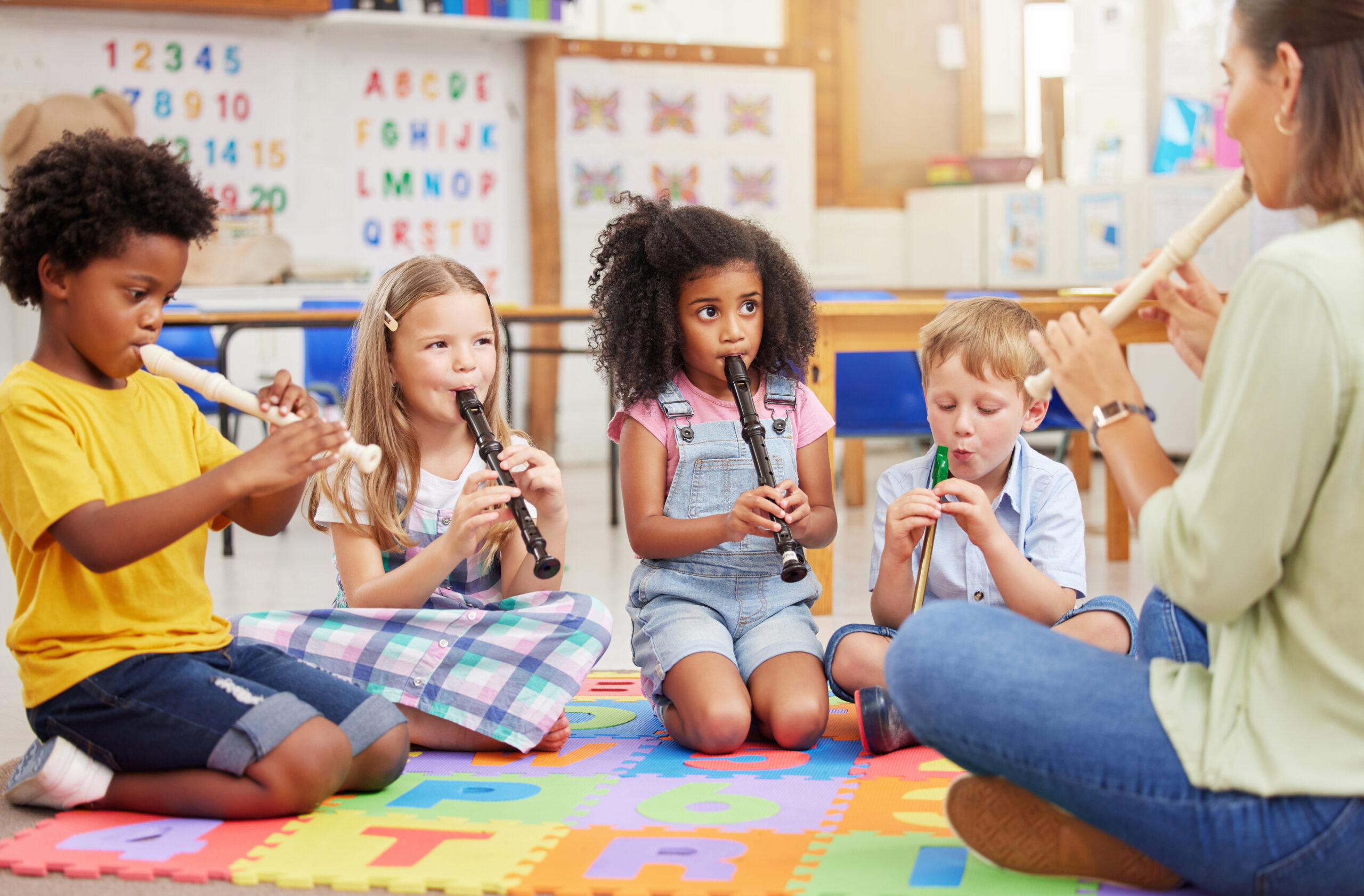 Shot of children learning about musical instruments in class.