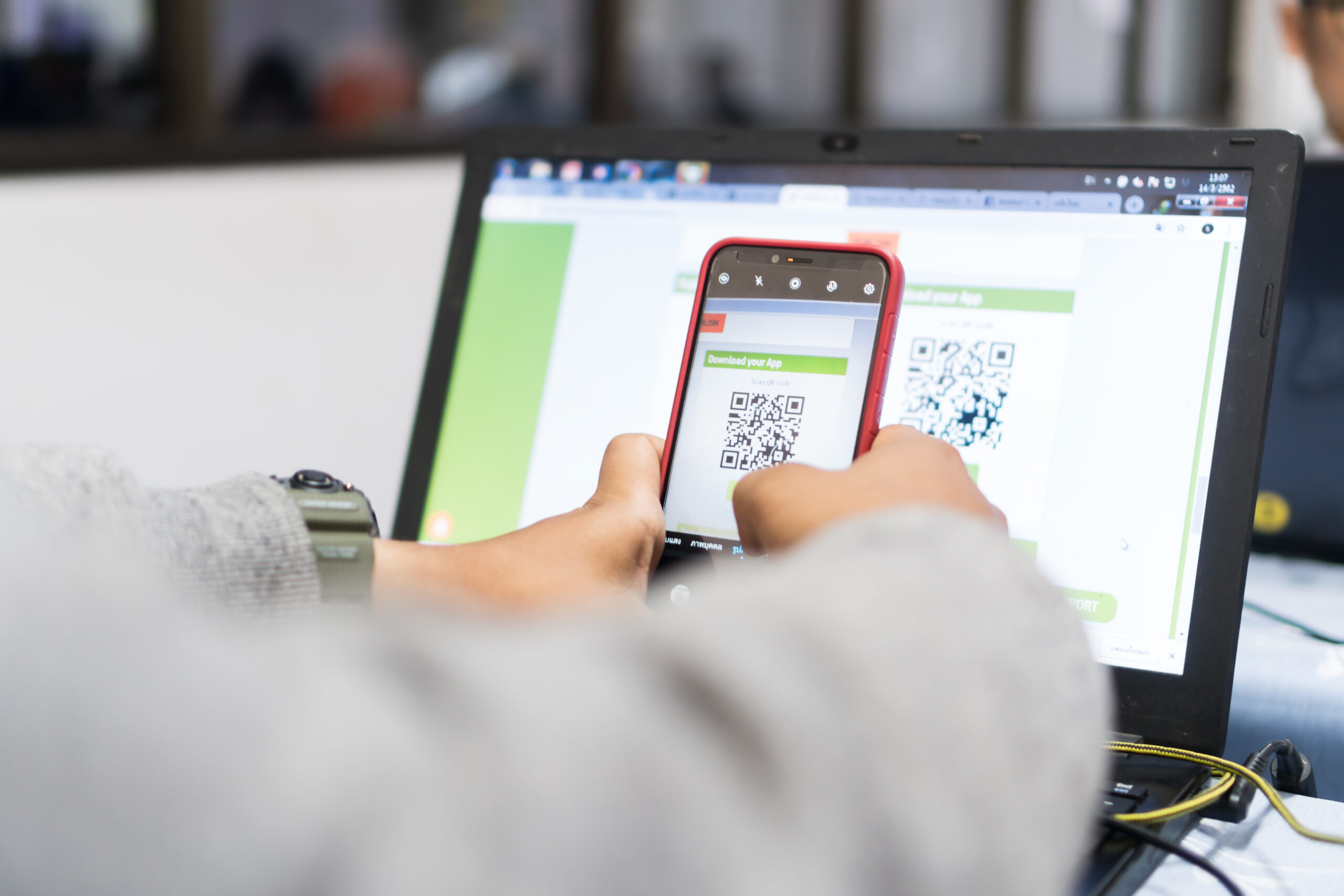 Students using QRcode smartphone apps on computer