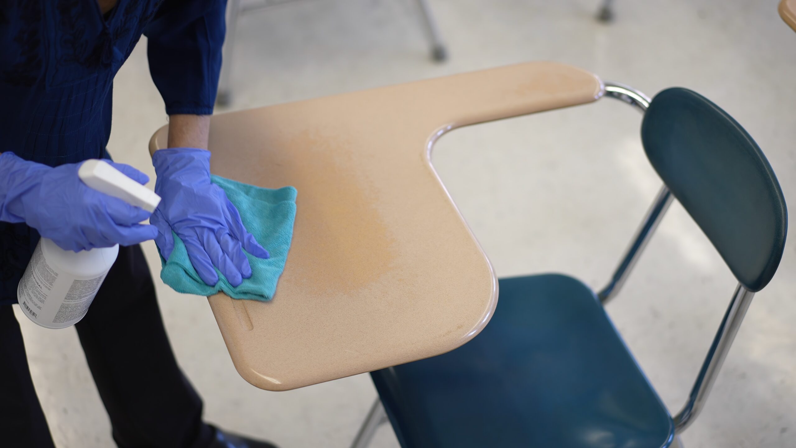Teacher at school after disinfecting desks.